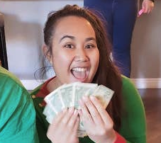 Janika holding cash money